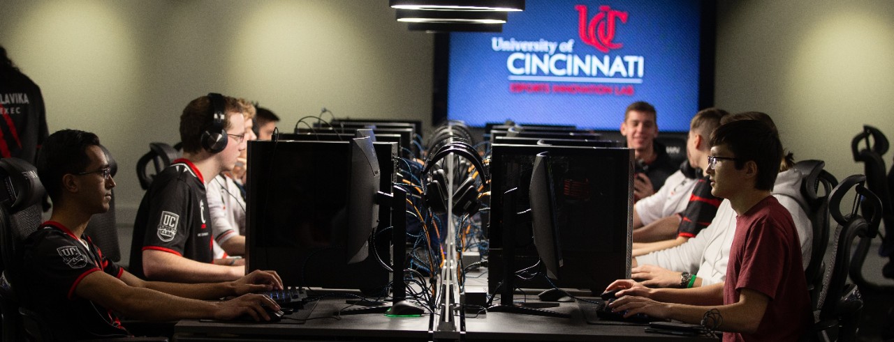 Students sit at desktop computers and play a game.