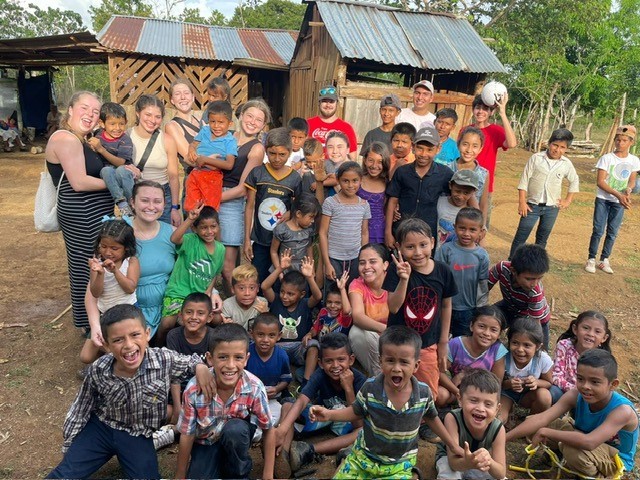 CAHS students in Costa Rica posing with children