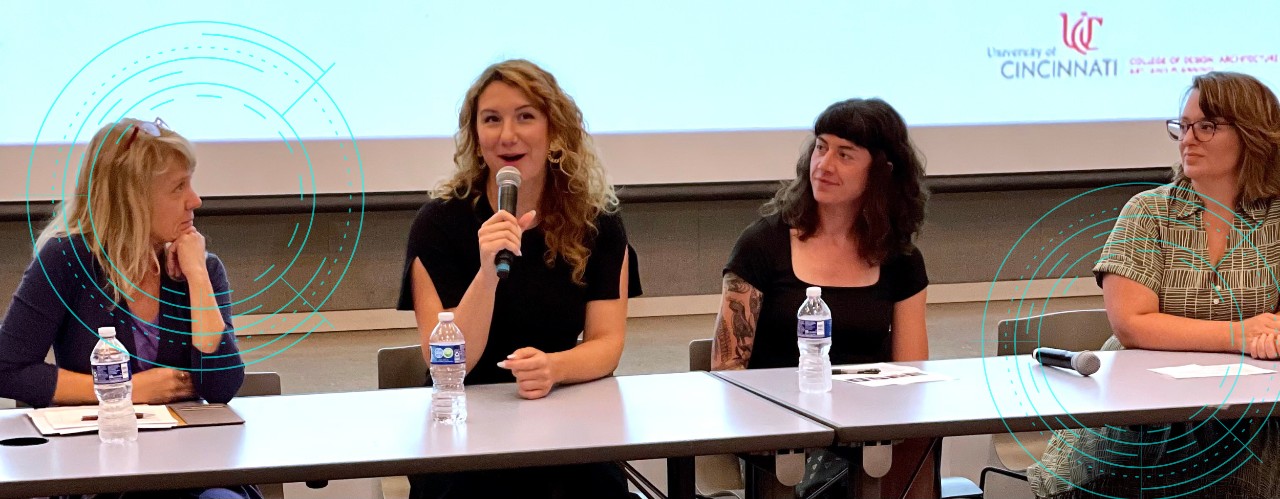 Four women sit at a table with mic during a UC DAAP panel discussion on creative entrepreneurialism 