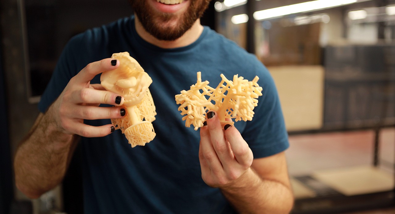 A man holding 3D printed items