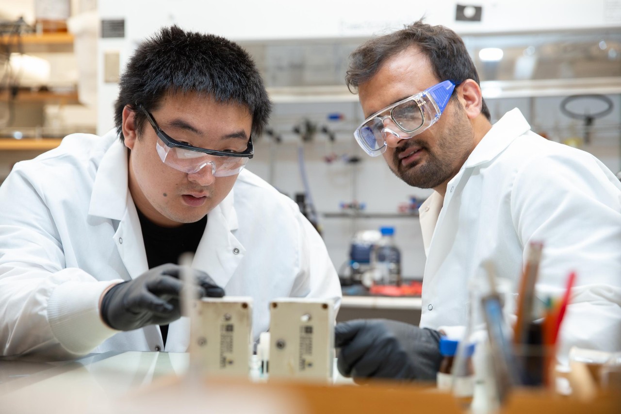 Jianbing "Jimmy" Jiang and his students working in his lab, where they have created a new battery with widespread applications for renewable energy.