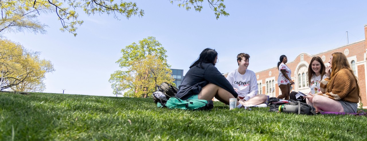 students sitting in grass