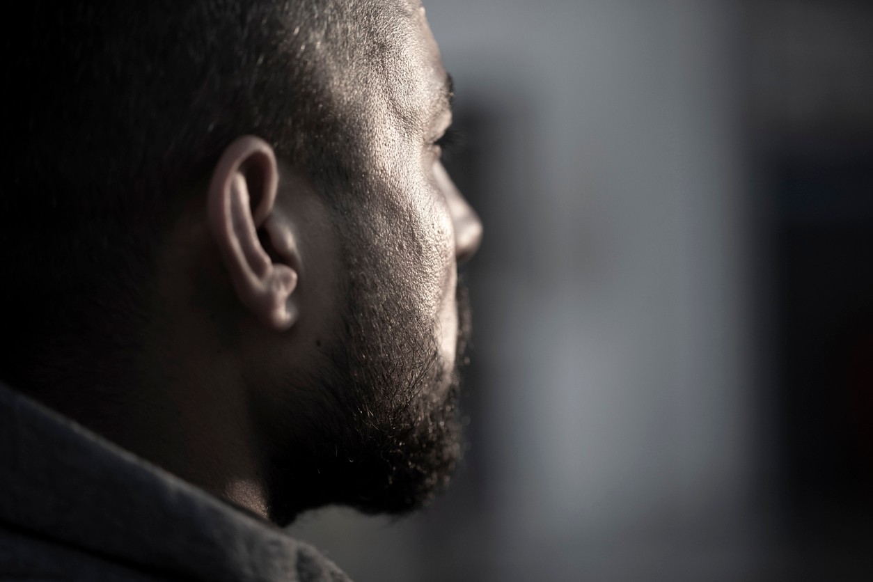 Man sitting in prison cell