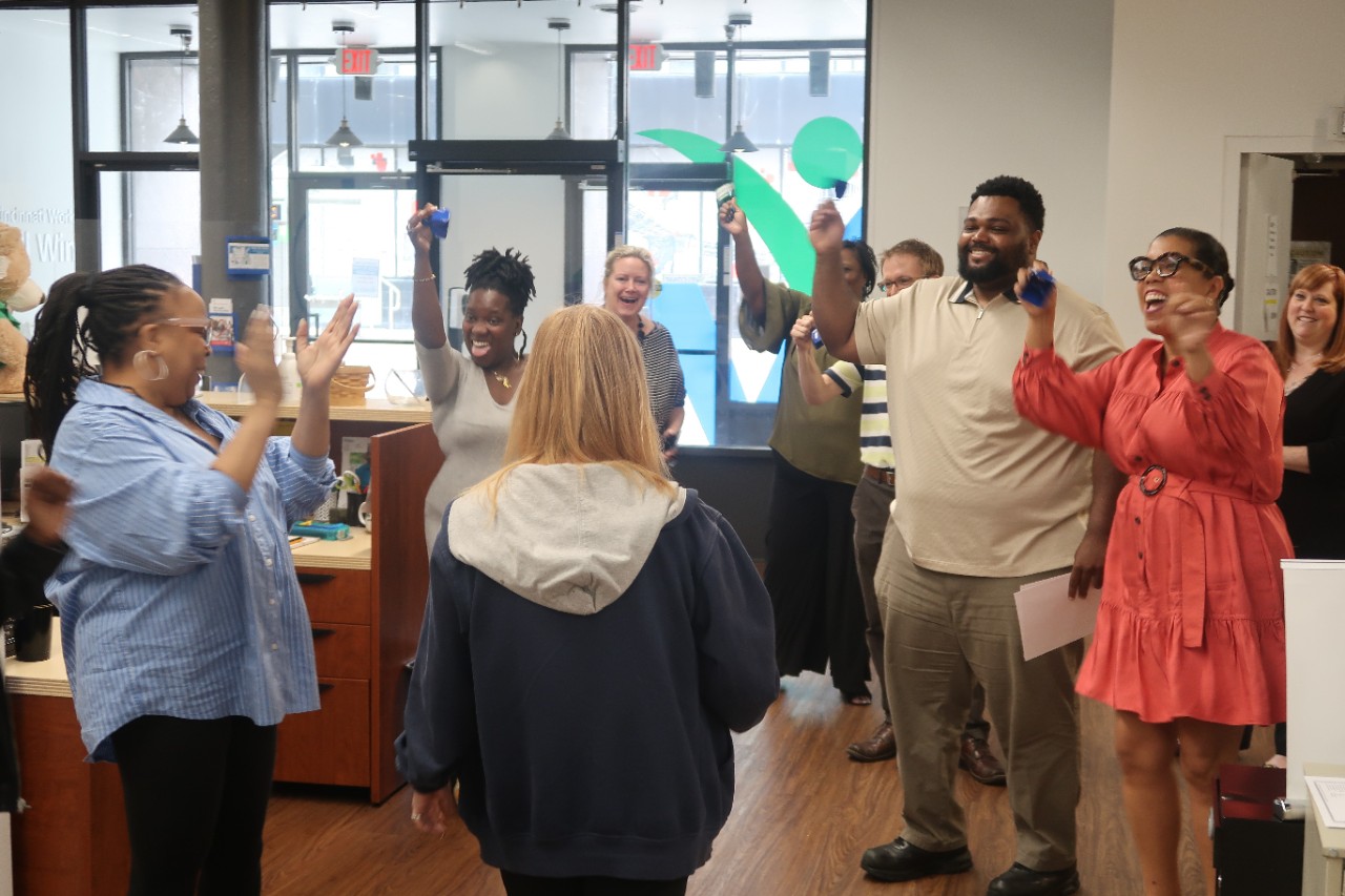 Tianay Amat, right, interacts with members and staff of Cincinnati Works