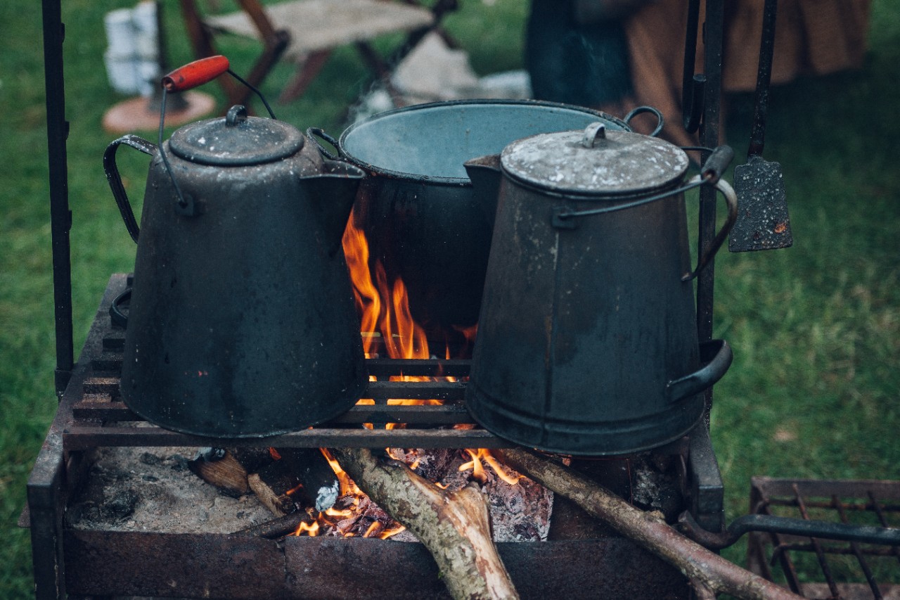 Coffee pots on an open fire.