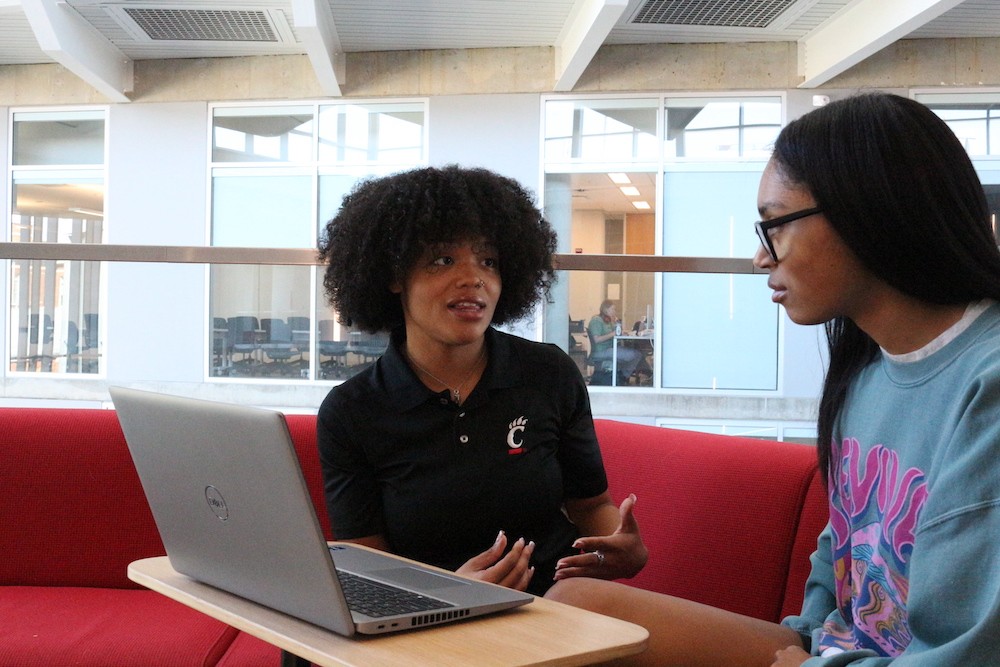 The success coach works with a student in the Health Sciences Building
