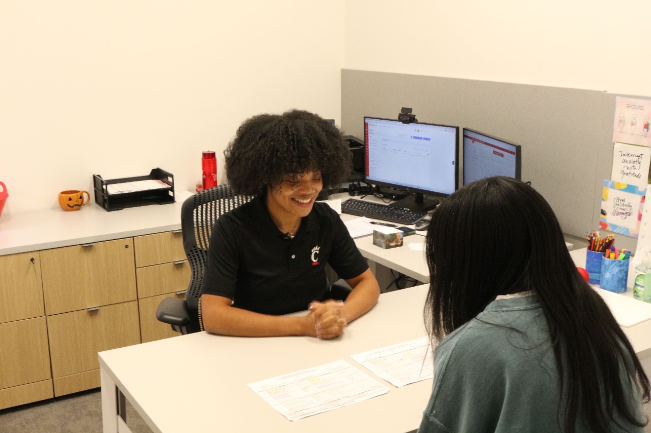 Ronay helps student in her office. 
