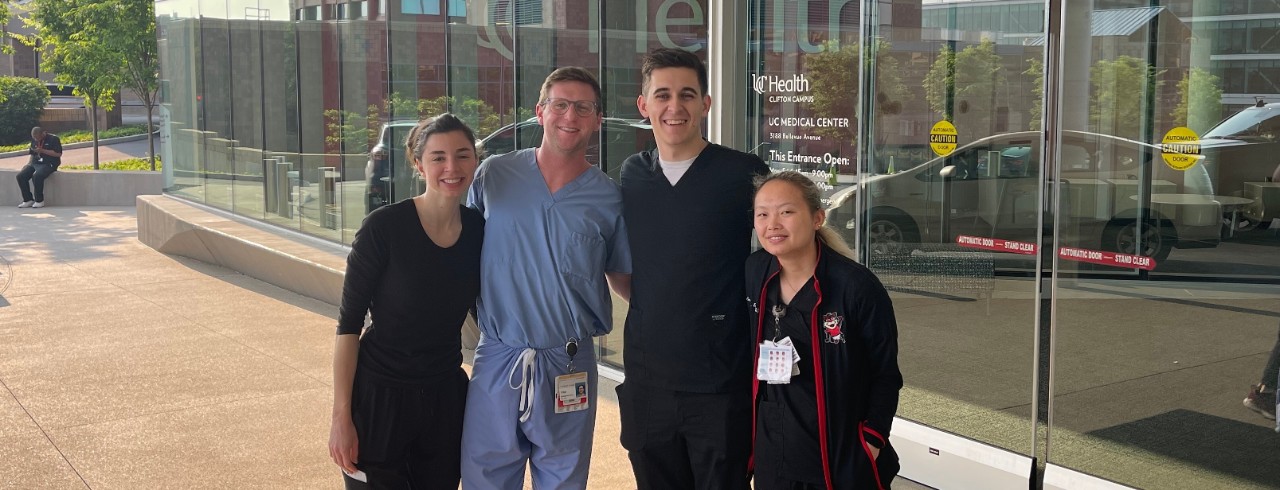 From left — Alumni Romie Suer, Tripp Elson, Anthony Palermo and Sophia Wells outside UC Medical Center where they work. 