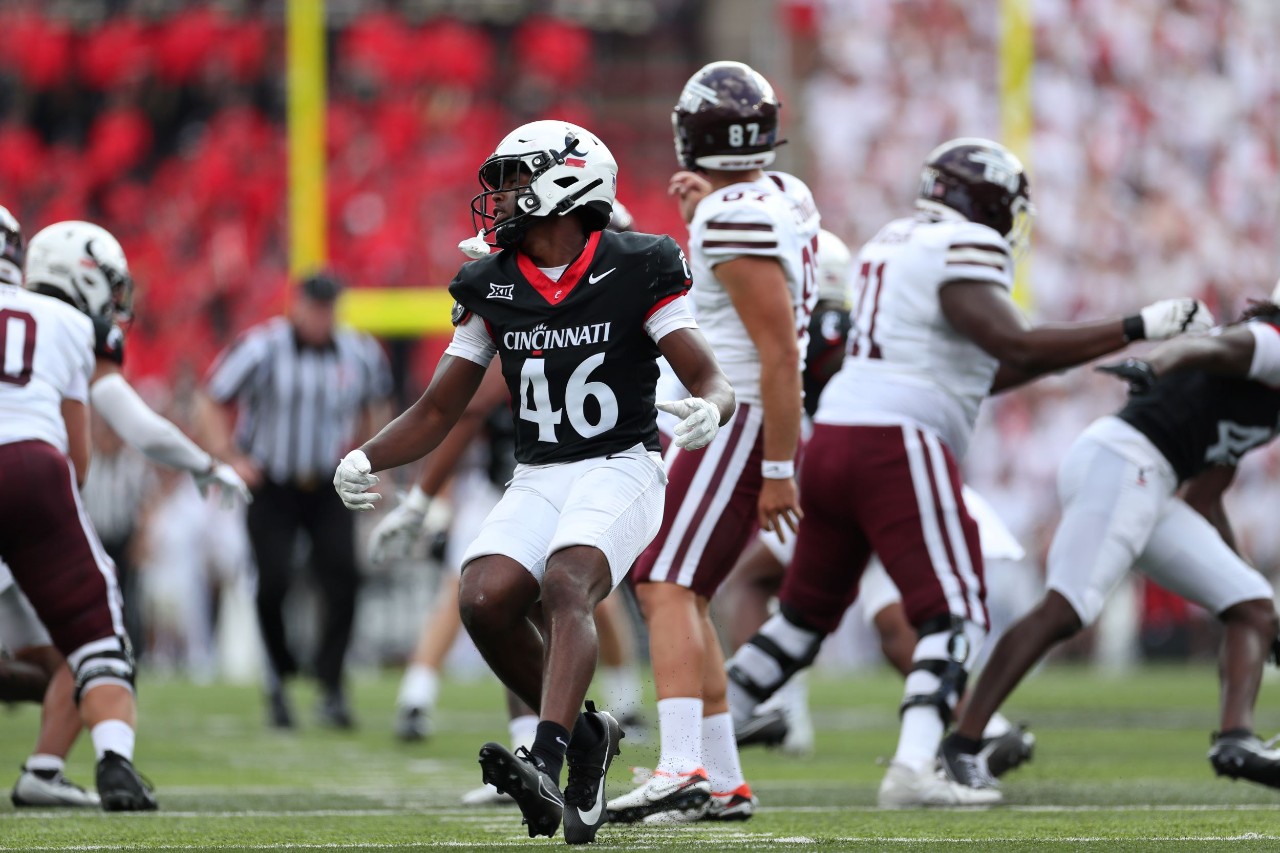 Image of Antwan Peek, number 46 jersey, on the football field in action with half a dozen male players around him