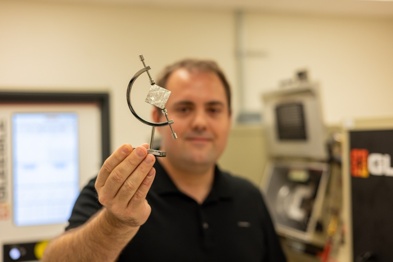 Image of Matt Steiner holding a meteorite piece.