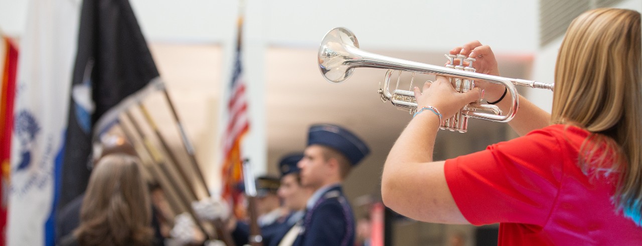 A bugler plays Taps for an honor guard.