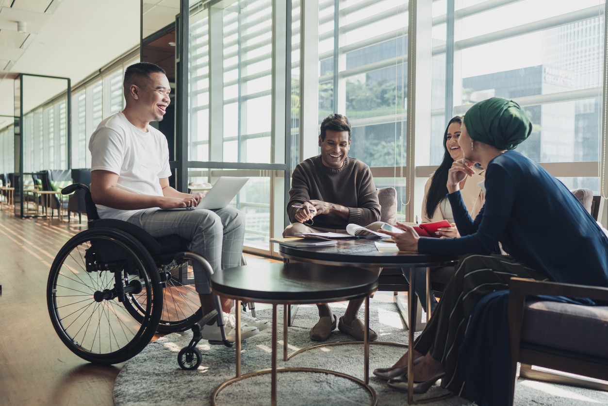 An inclusive business team featuring staff members of several ethnicities and disabilities