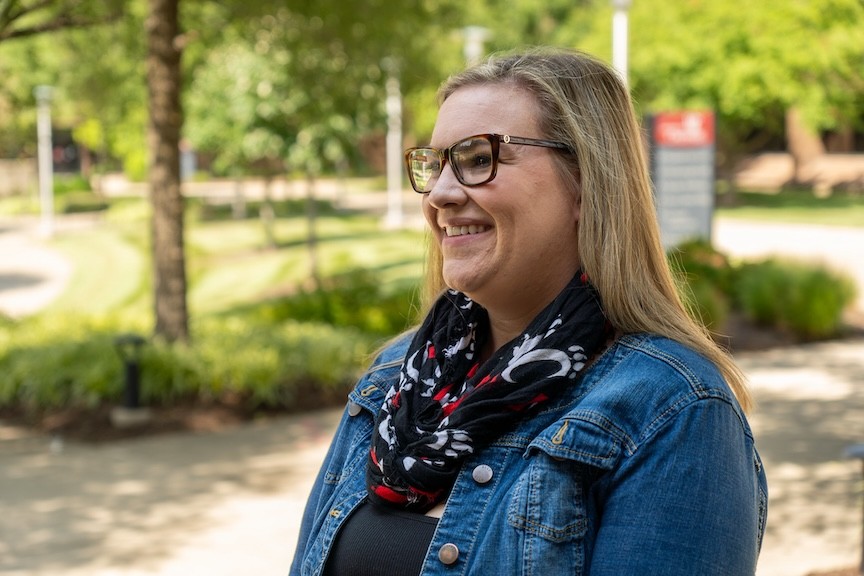 student outside on campus, looking off camera