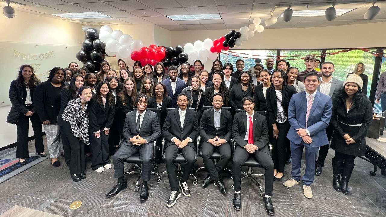 Business Fellows in professional attire pose for a photo in the Everett Cintas location conference room.