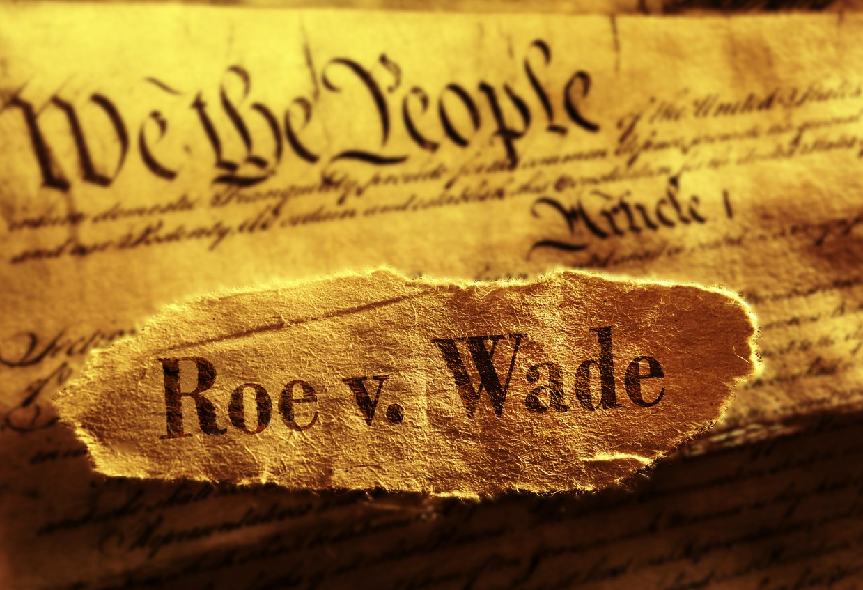 Roe v. Wade newspaper headline on top of the US Constitution