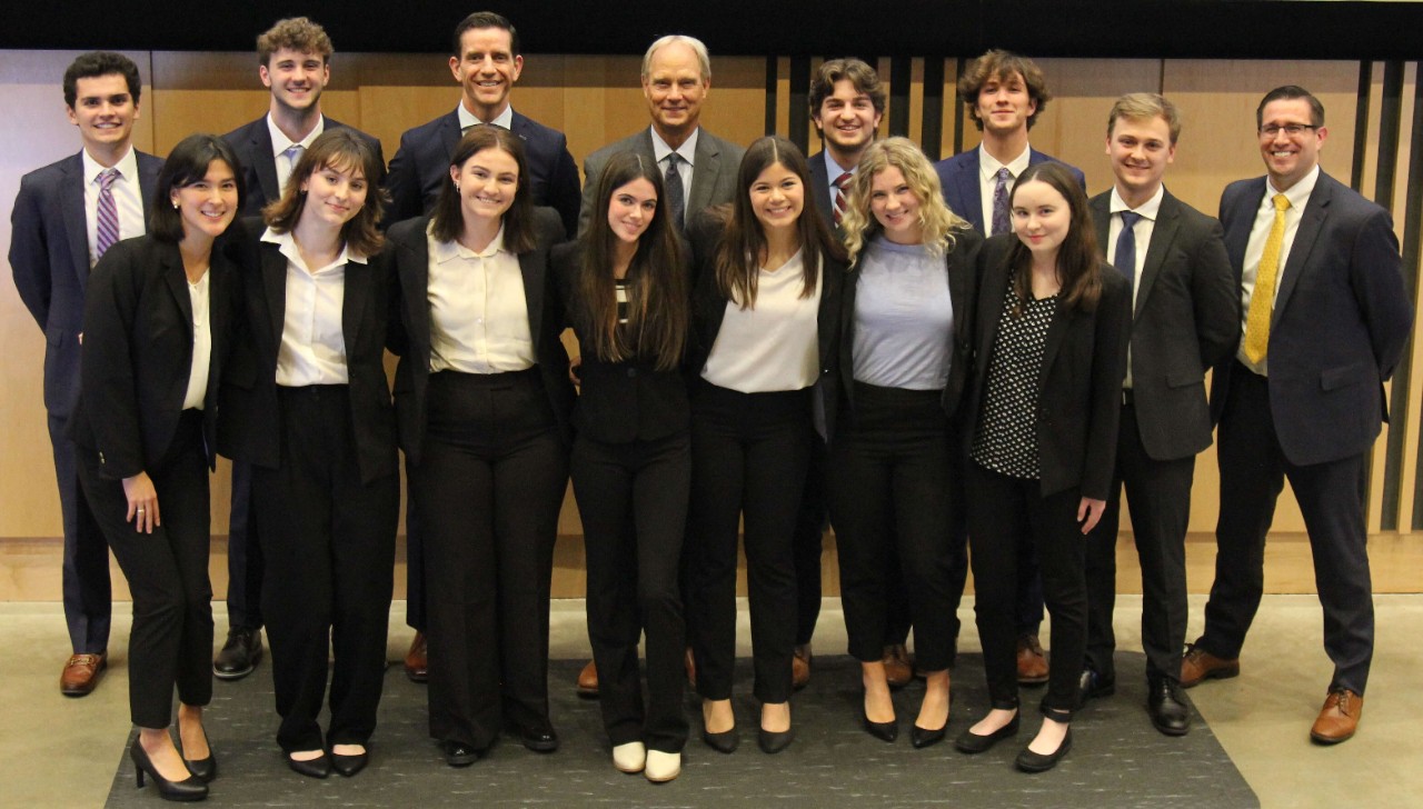 Lindner first-year students dressed in professional attire pose for a picture with Cintas representatives.