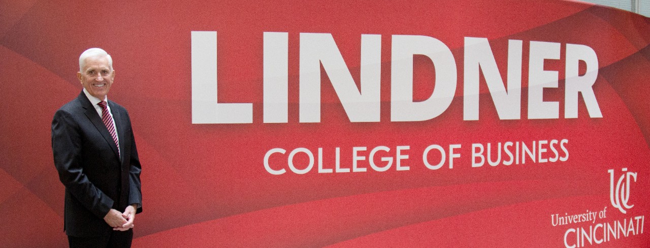 Jim Grau in front of Lindner College of Business sign
