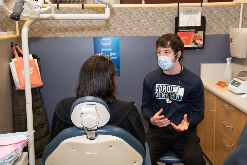 Dr. Jackson Boone consulting with a seated patient