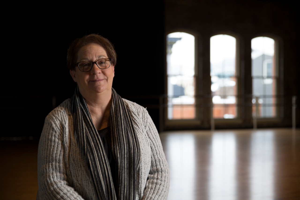 Nancy Smith, OIP exoneree, sits in an empty room