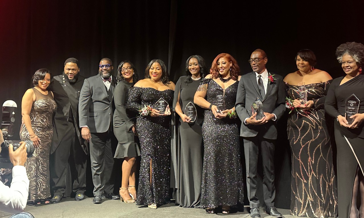 The award recipients from the 2024 Onyx & Ruby Gala stand together centerstage Feb. 17.