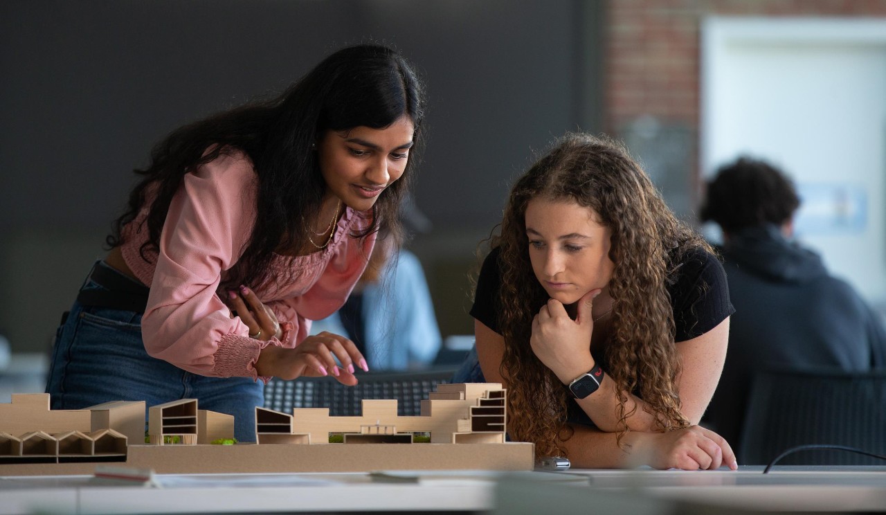 Two University of Cincinnati students analyze a project in class.