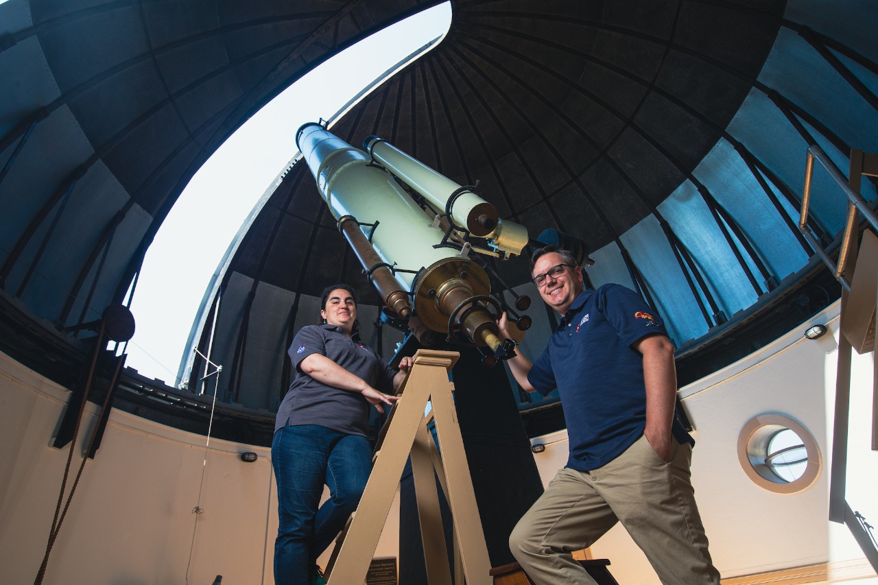 Andrea Corpolongo, left, and Andy Czaja stand in front of a telescope at the Cincinnati Observatory.