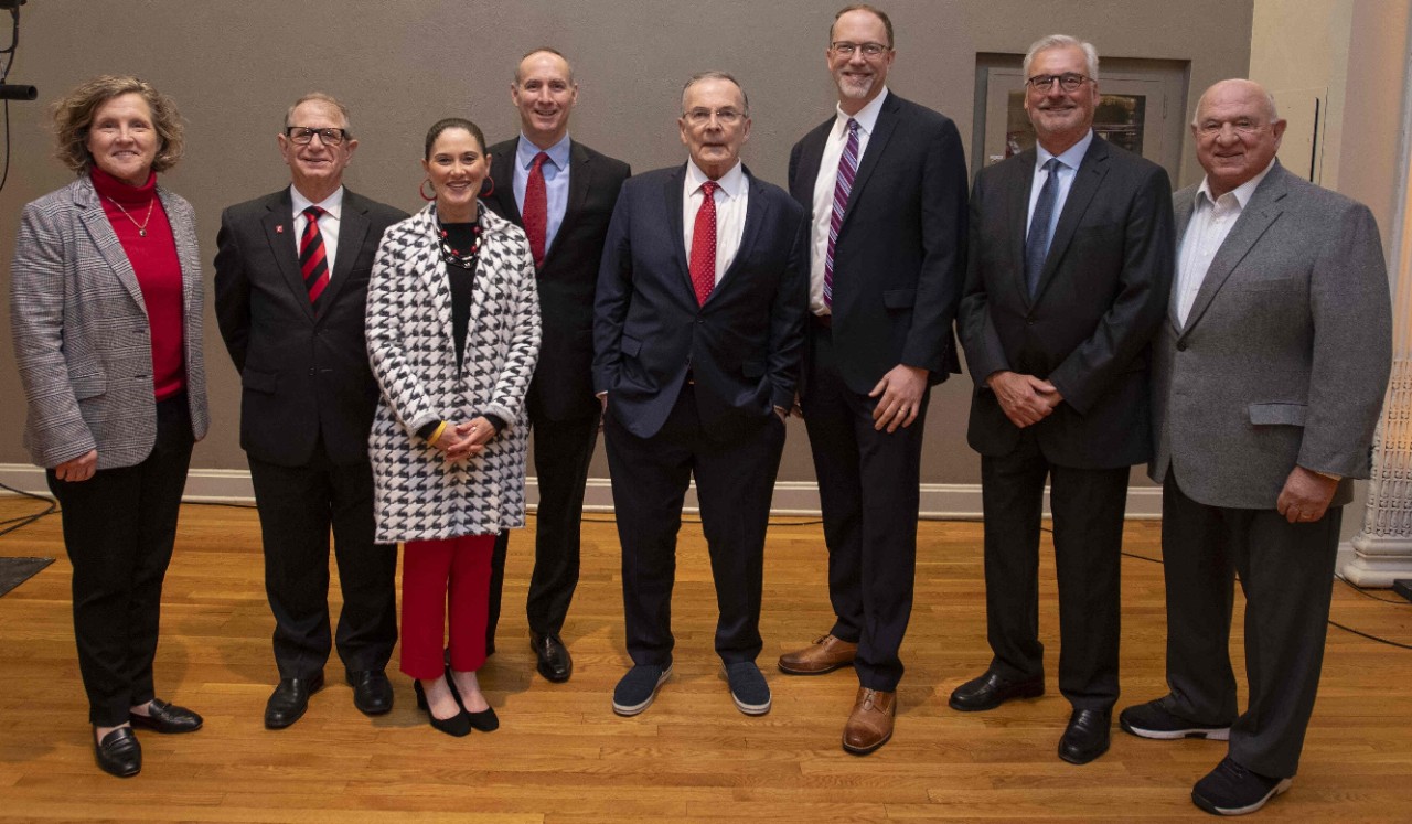 UC Real Estate stakeholders pose with Economic Outlook speakers, all in professional dress.