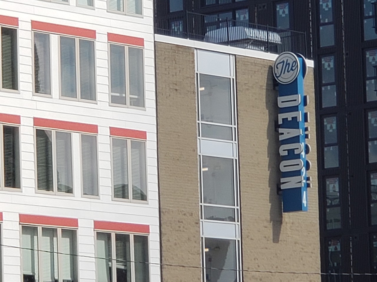 image of an apartment building with a sign reading Deacon