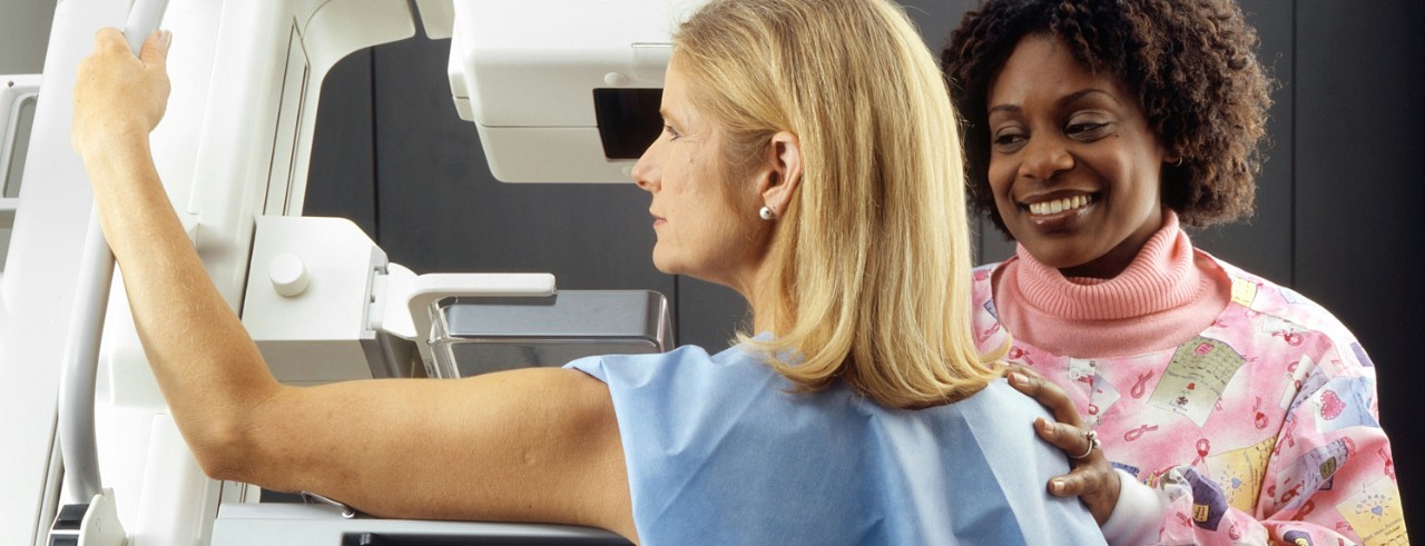 A woman receives a mammogram.
