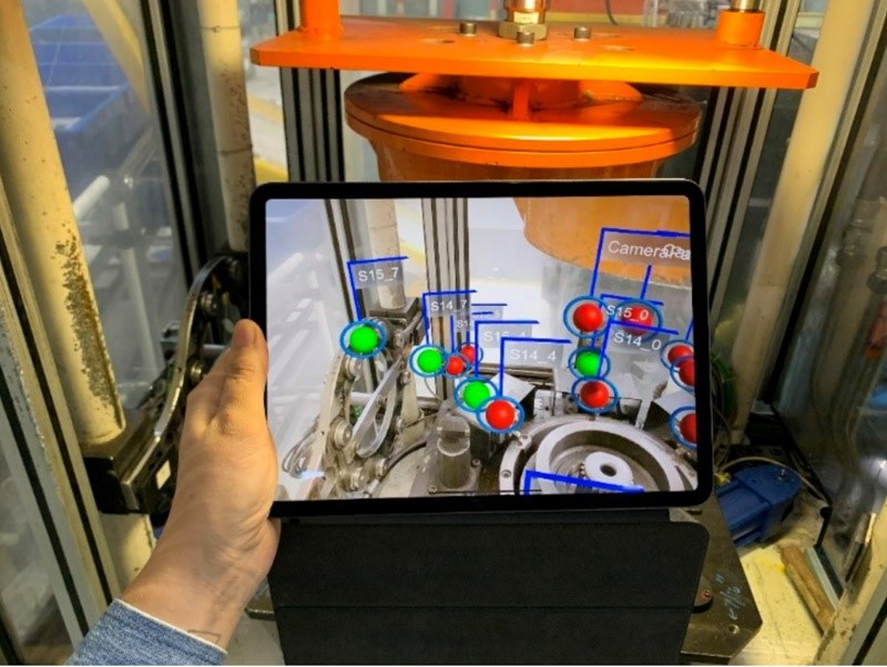 An augmented reality depiction on a tablet computer of an industrial machine.