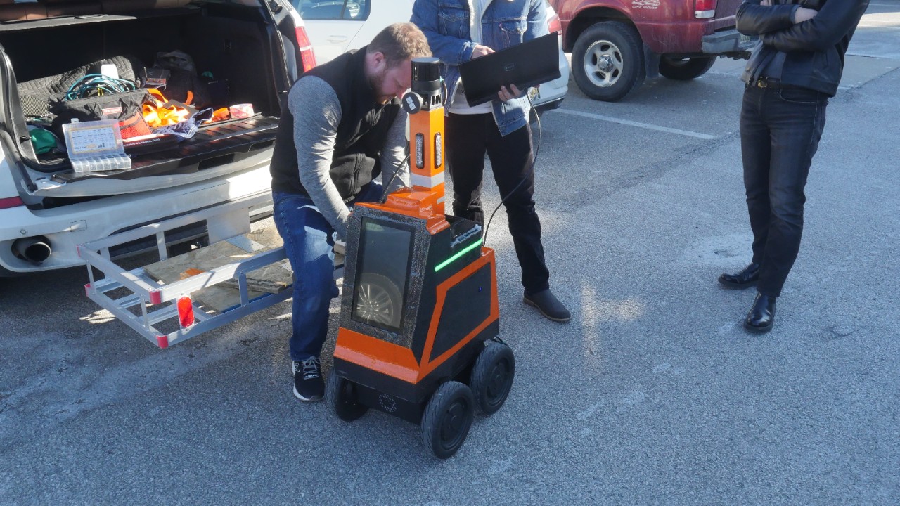 Airtrek co-founder Jon Taylor works on a robot outside the 1819 Innovation Hub