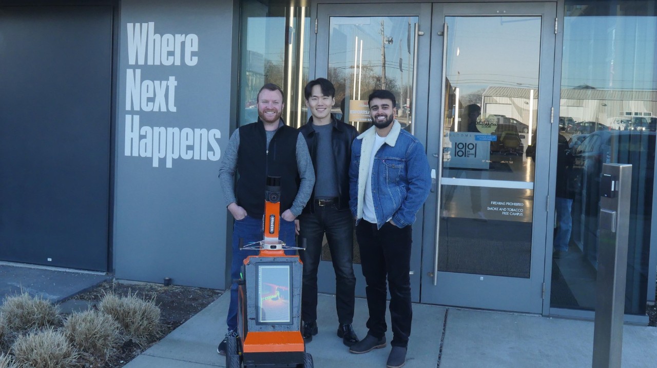 Airtrek co-founders stand with robot