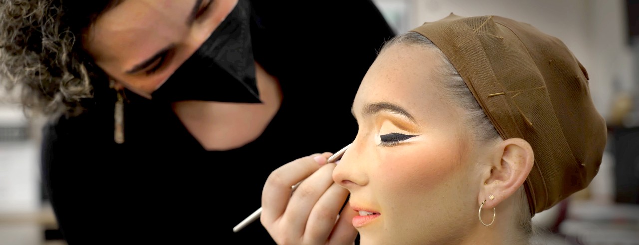 Senior musical theatre major Grace Marie Rusnica has her stage make-up applied by make-up and wig design graduate student Claire Bonnette in a scene from CCM's "The Making of Sweet Charity" mini documentary.