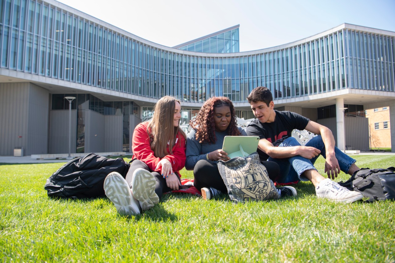 students on the lawn of the allied health sciences building