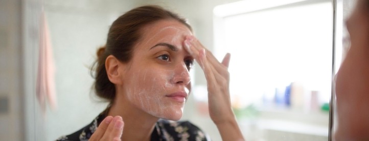 A woman washes her face