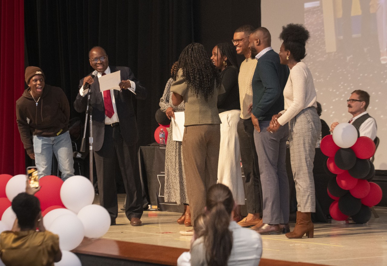 Dami Fakunle, middle looked on as her father read that she matched to George Washington during the University of Cincinnati 2024 Match Day ceremony in Kresge Auditorium at Care/Crawley Friday March 15, 2024. Photos by Joseph Fuqua II