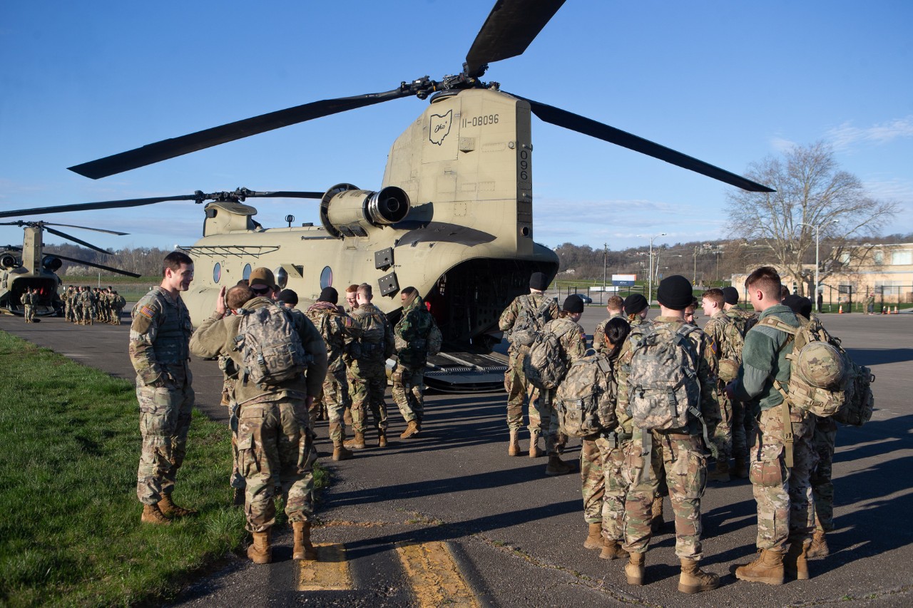 UC ROTC students in military fatigues climb aboard a Chinook helicopter at Lunken Airport.