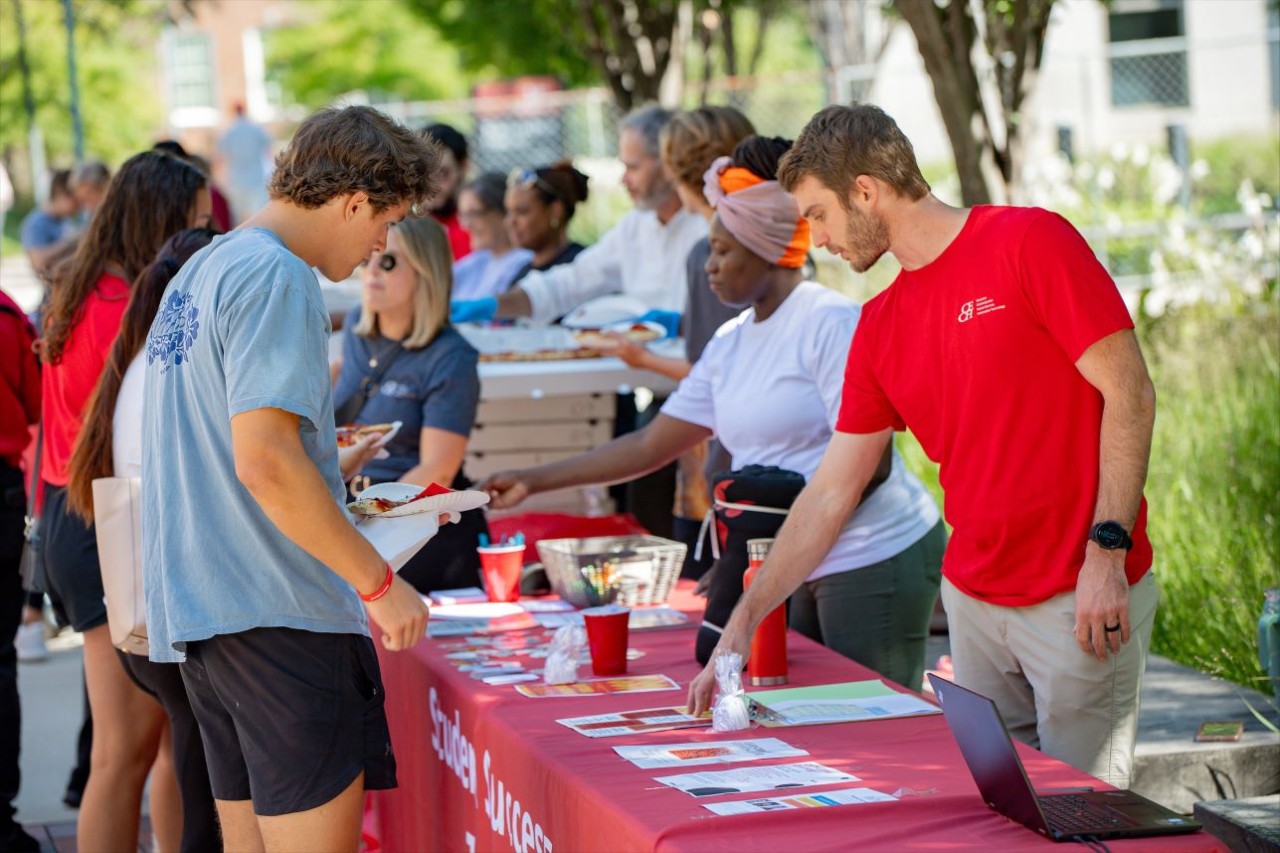 CECH team serves food to students