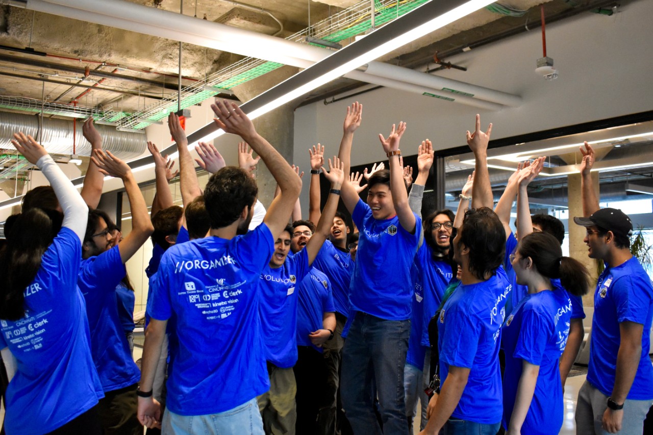 RevUC students celebrate hackathon success. 