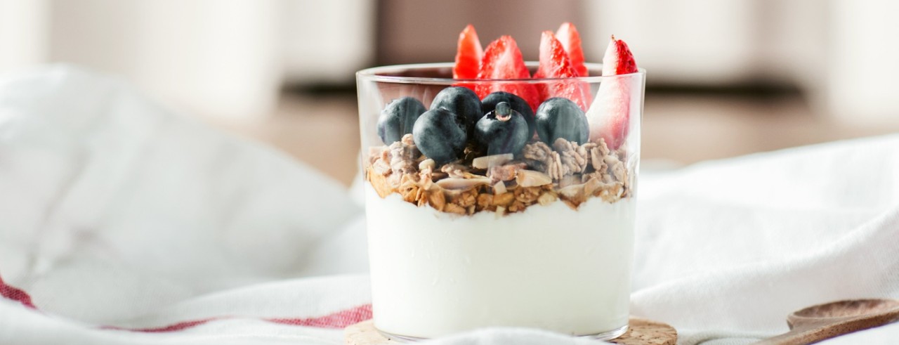A bowl of Greek yogurt with granola and berries