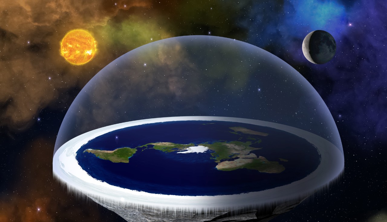 Flat earth graphic with sun and moon hoovering over disc of earth. Istock photo by buradaki 