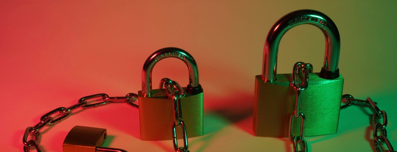 Stock image of padlocks connect by a chain.