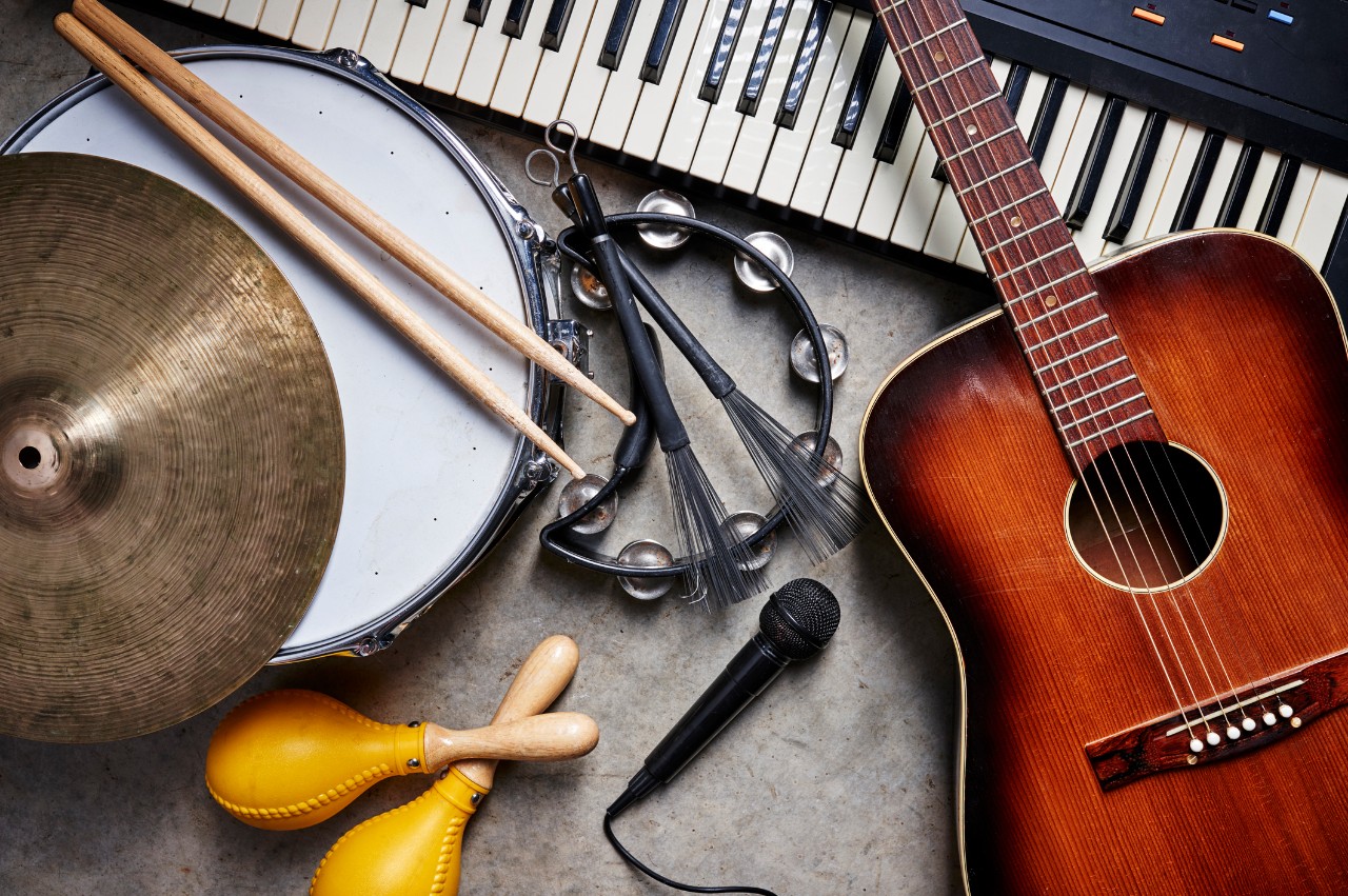 image of musical instruments showing piano, guitar, tamberine, and others