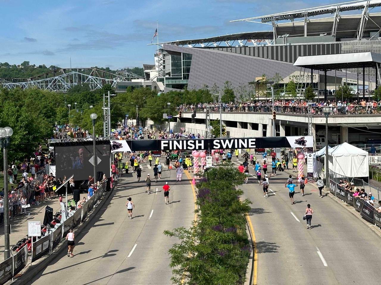 Runners cross the finish line at the Flying Pig marathon.