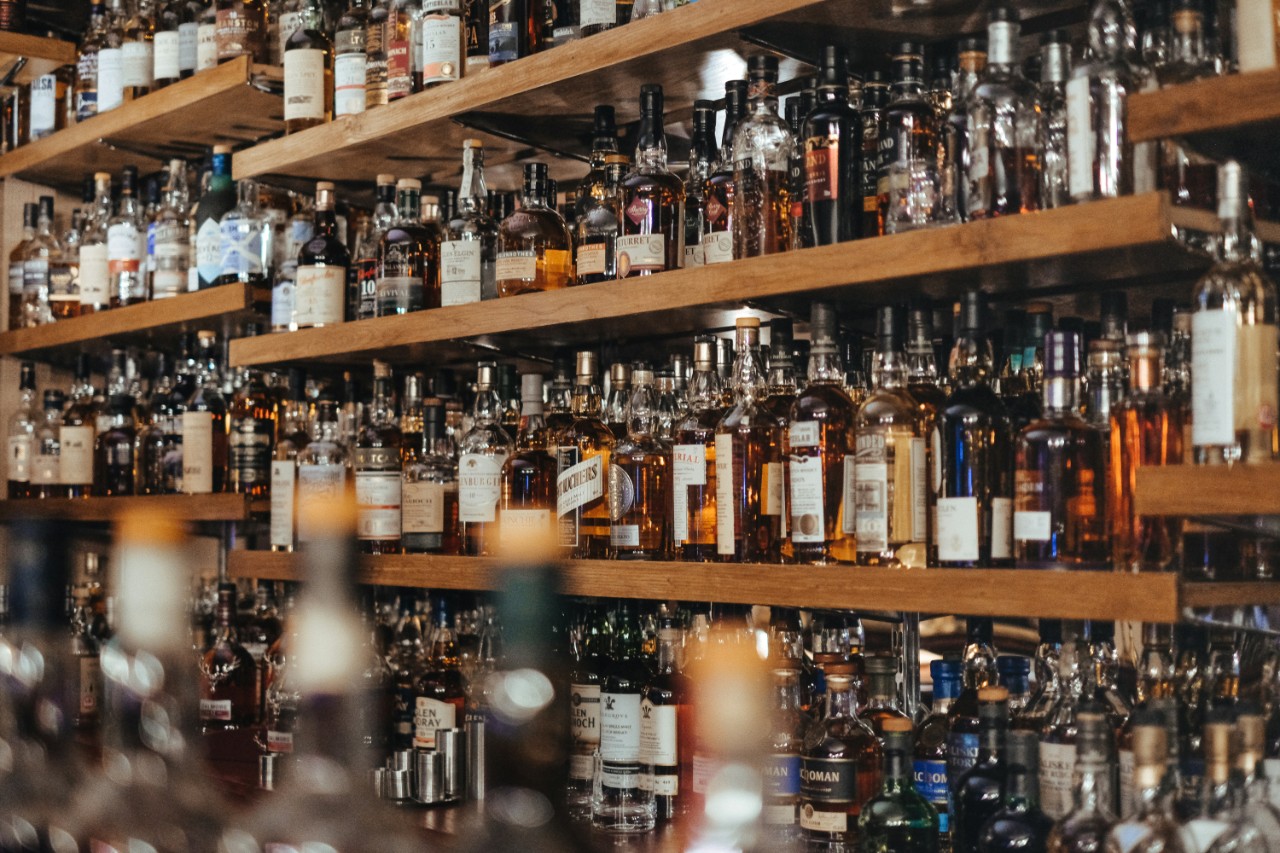 Bottles of alcohol on wooden shelves
