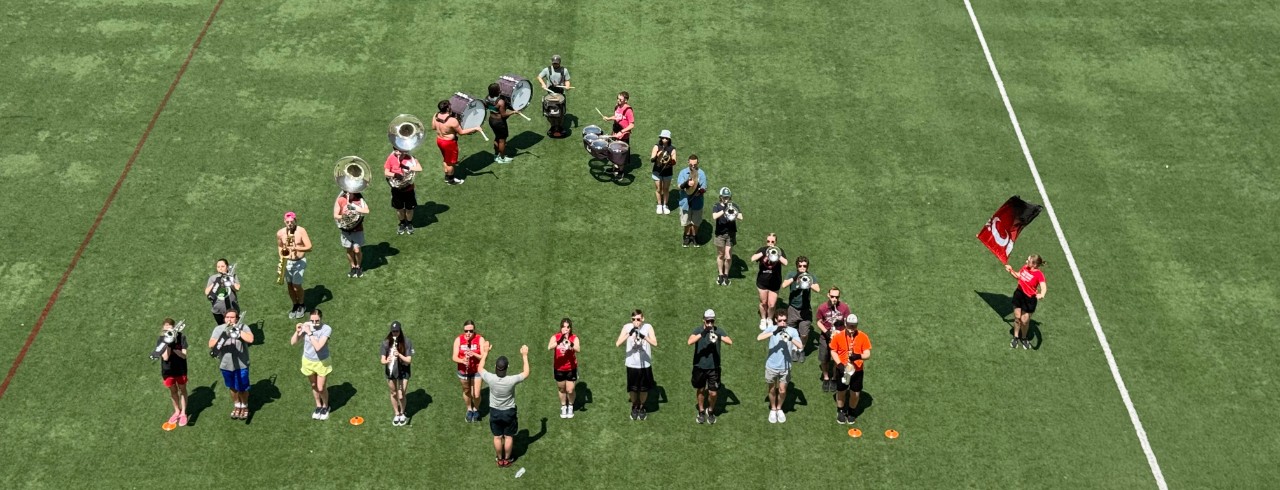 Members of the marching band practice on UC's campus before an international trip to Egypt.