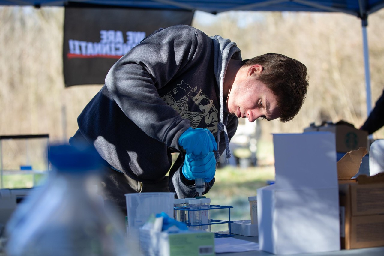 A UC student works with a water sample at UC's groundwater observatory along the Great Miami River.