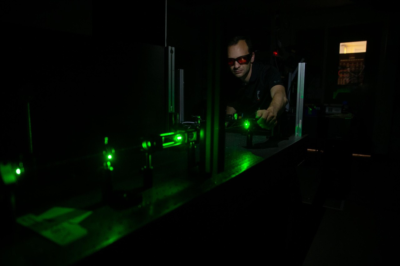 Pietro Strobbia uses a laser in his chemistry lab.