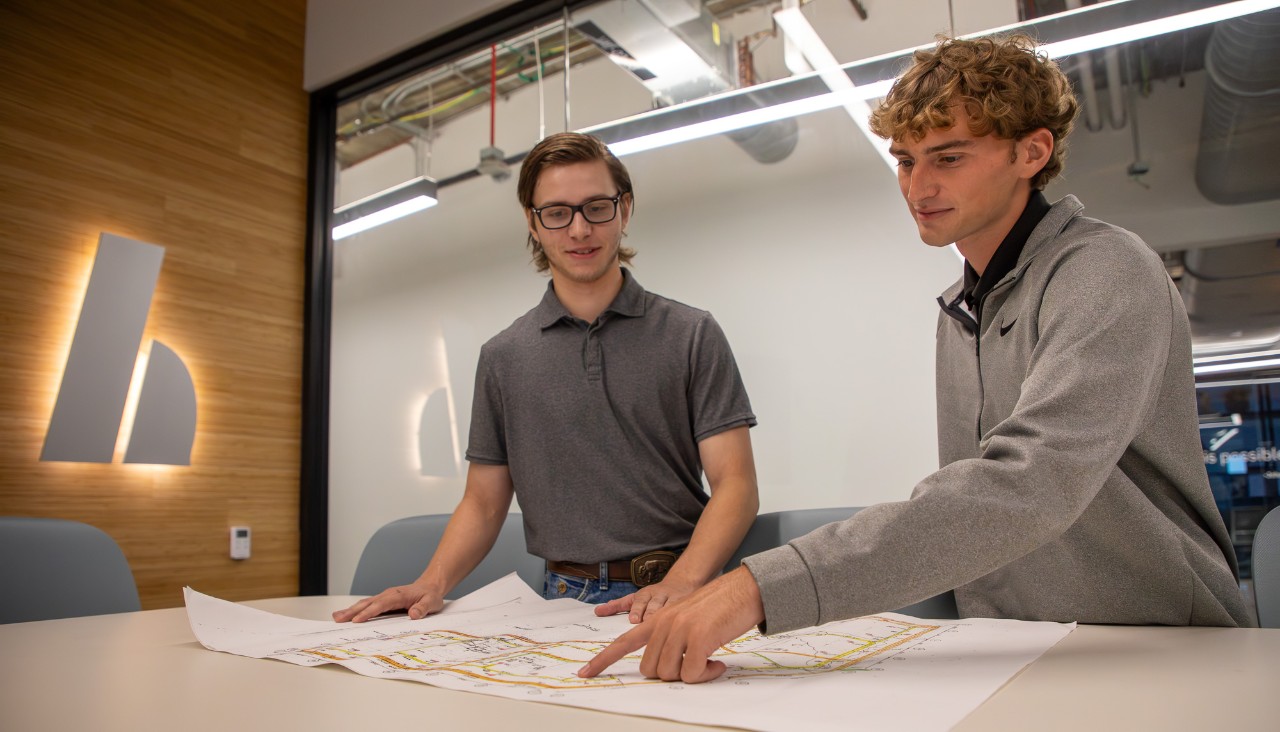 Two UC students work on blueprints at HEAPY.