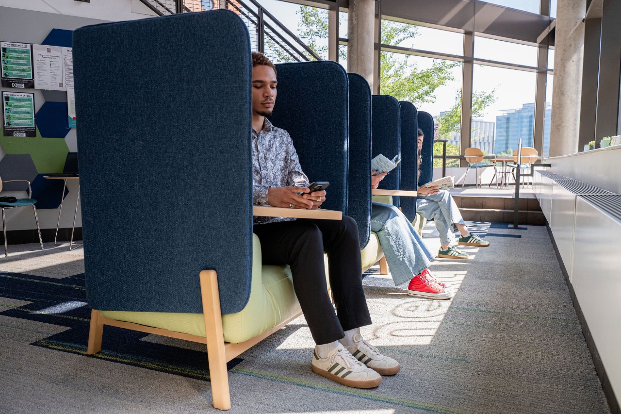 A student sits in a quiet chair inside the Student Wellness Center